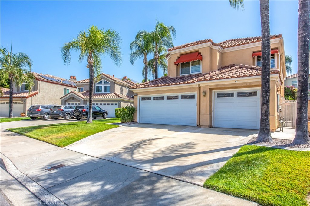 7751 Jack Rabbit Lane Highland, CA 92346 - Photo 47 of 50 a front view of a house with a garden and palm trees