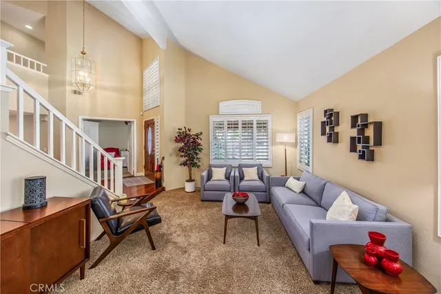 a living room with furniture and a potted plant