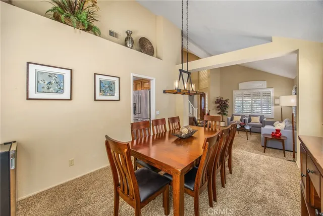 a view of a dining room with furniture and chandelier