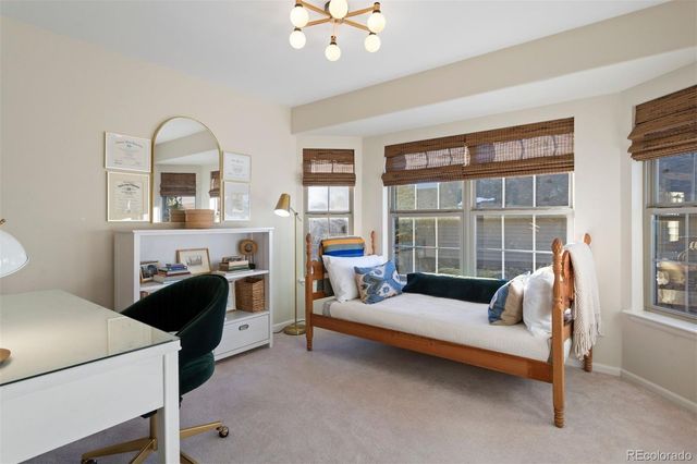 a bedroom with furniture and a window