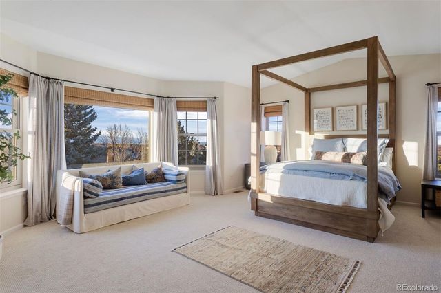 a bedroom with a bed and glass window