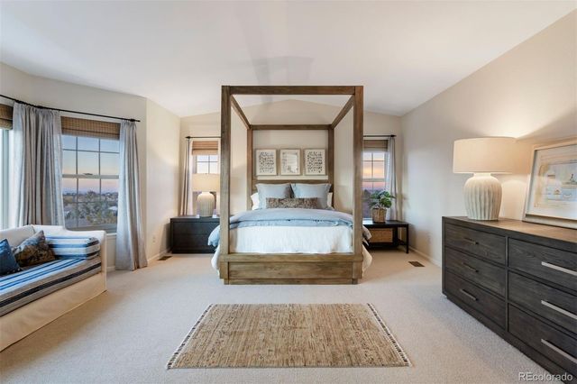 a spacious bedroom with a large bed and a window