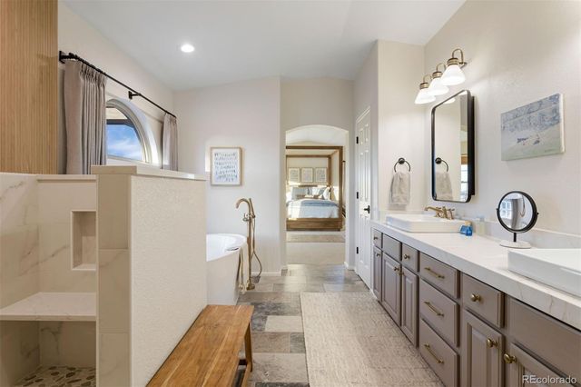 a spacious bathroom with a double vanity sink and a mirror
