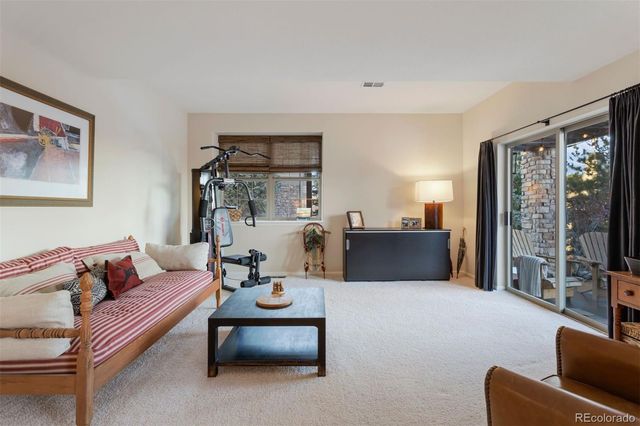 a living room with furniture a flat screen tv and a large window