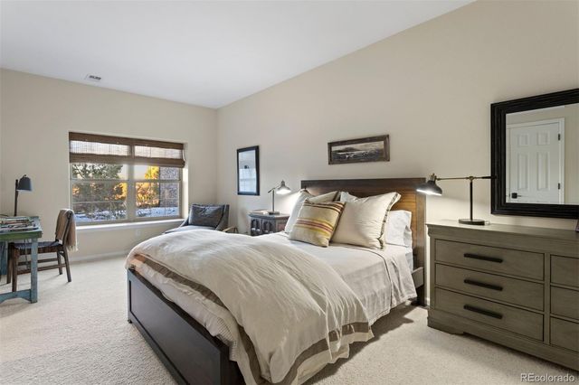 a bed room with a bed and a chair