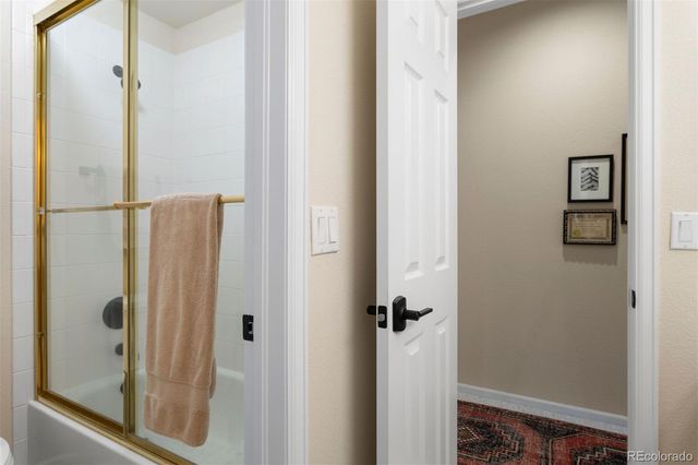 a bathroom with a glass shower door