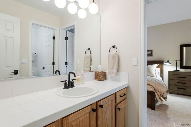 a bathroom with double vanity sink and a mirror
