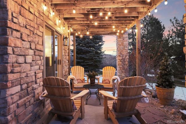 a couple of chairs sitting in patio in front of building