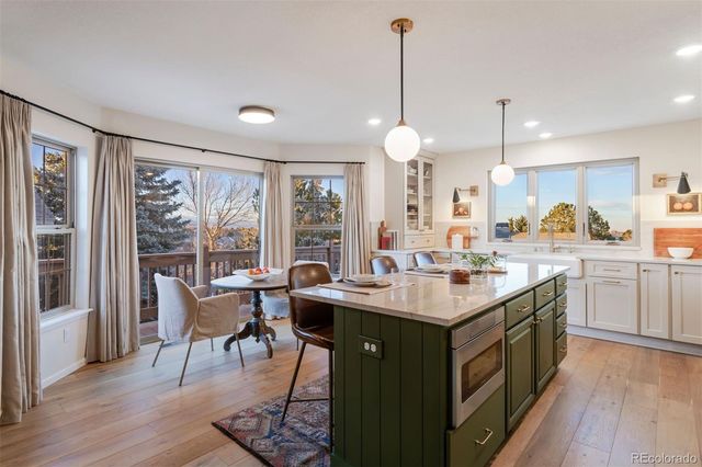 a kitchen with sink stove and wooden floor