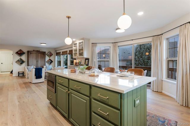 a kitchen with counter top space sink and a chandelier
