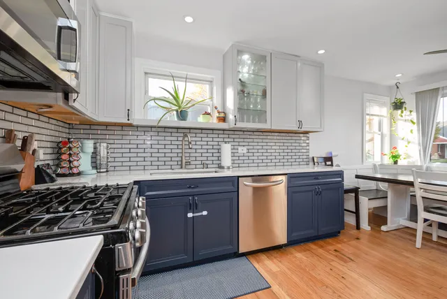 a kitchen with stainless steel appliances granite countertop a stove and a sink