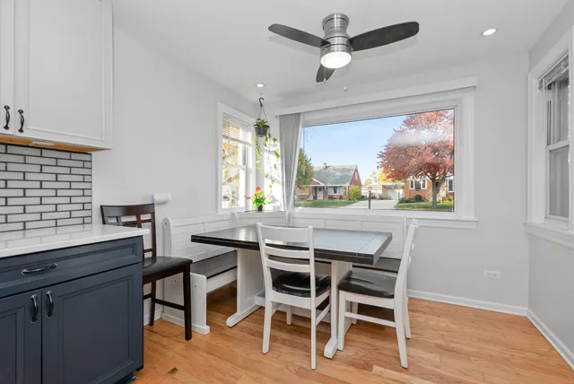 a dining room with wooden floor and a window