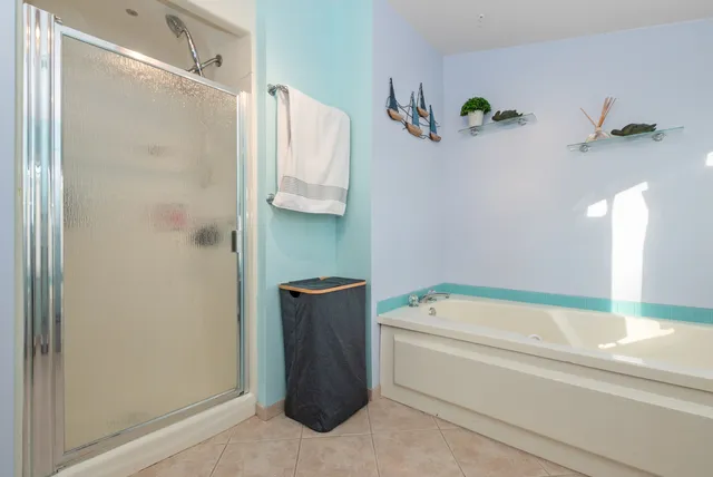 a bathroom with a tub shower and vanity