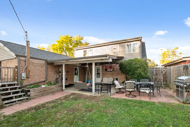 a view of a house with backyard porch and sitting area