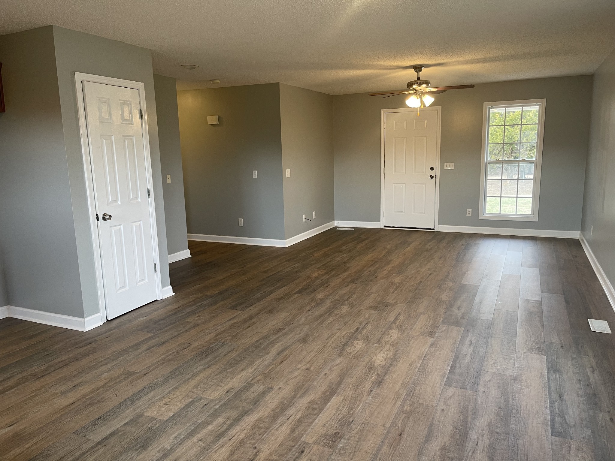 274 Johns Cemetery Road Pulaski, TN 38478 - Photo 4 of 13 a view of an empty room with wooden floor and window