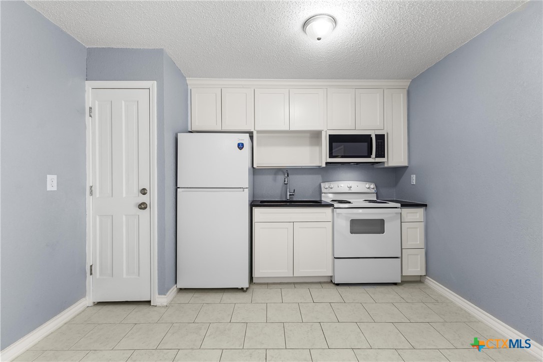 104 East Arlo Road Harker Heights, TX 76548 - Photo 12 of 35 a white refrigerator freezer sitting in a kitchen