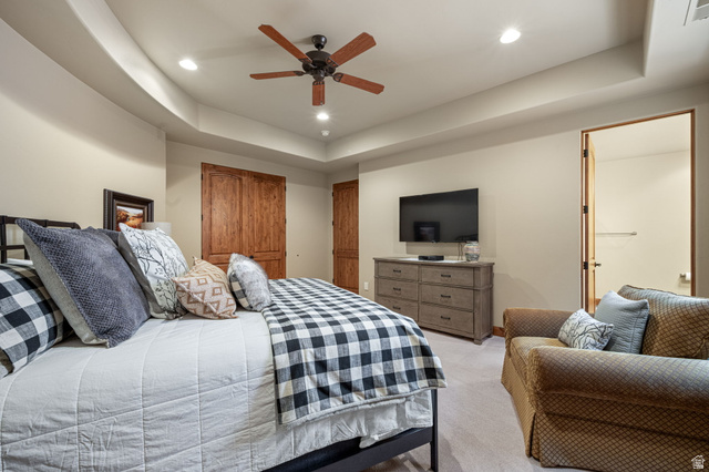 2331 West Entrada Trail, Unit 61 St. George, UT 84770 - Photo 43 of 69 Spacious bedroom featuring plush carpeting, a tray ceiling with recessed lighting, and a wood-finish ceiling fan