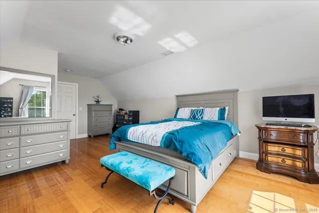 a bedroom with a bed and a television