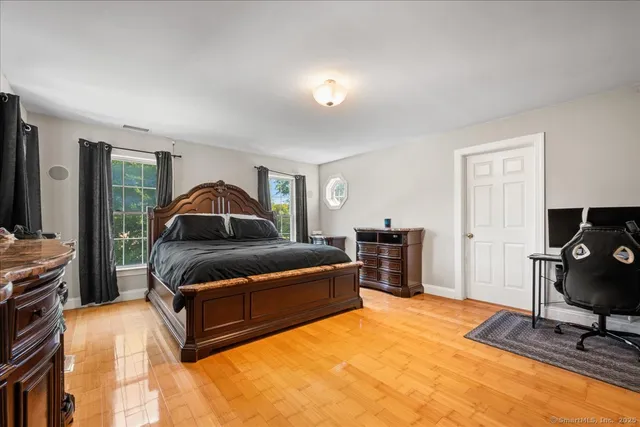a bedroom with furniture and a flat screen tv