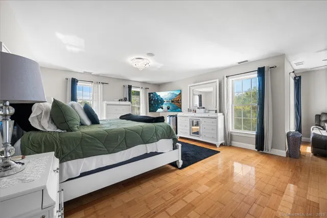 a bedroom with a large bed and a window