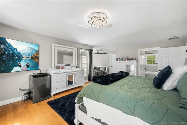 a bedroom with a bed and a chandelier