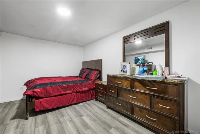 a living room with a bed and a dresser