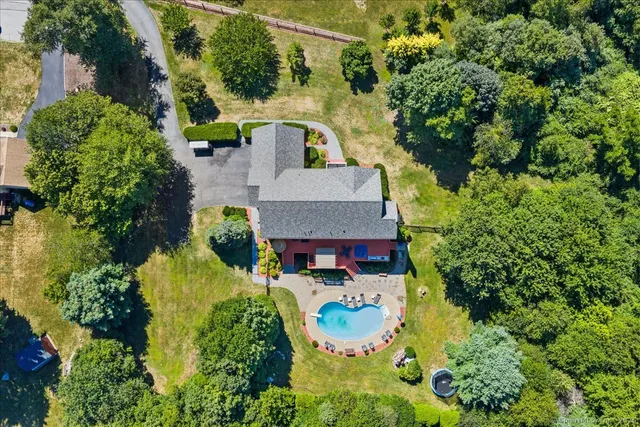 an aerial view of a house with yard swimming pool and outdoor seating
