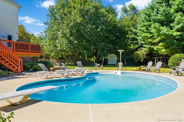 a view of swimming pool with outdoor seating and yard