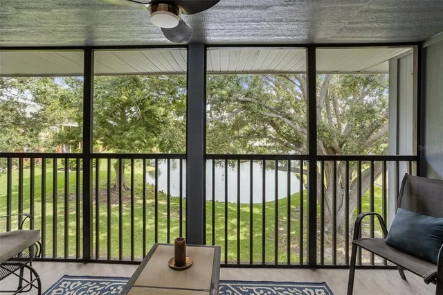 a view of a room that has a bed and wooden floor