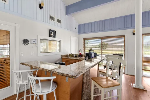 a view of a dining room with furniture wooden floor and a chandelier