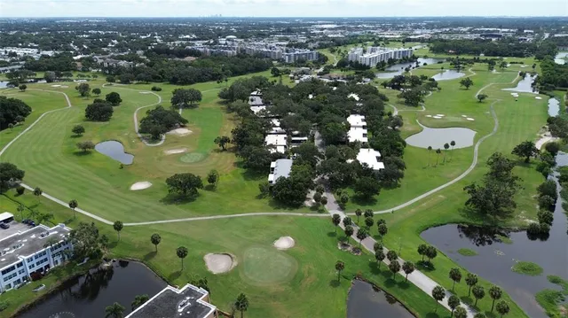 an aerial view of a golf course with parking space