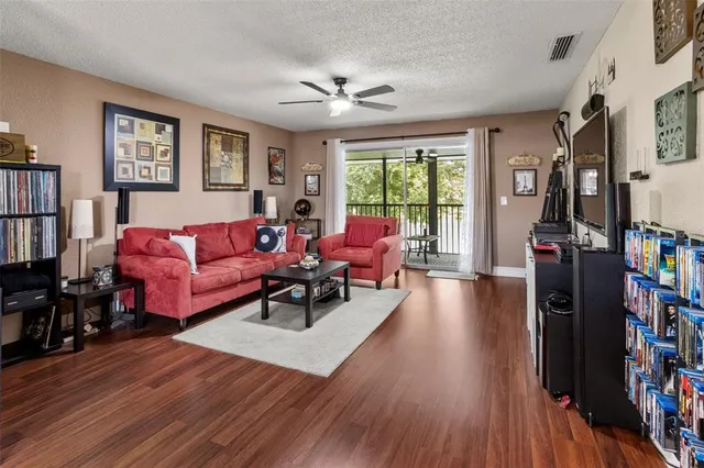a living room with furniture and a wooden floor