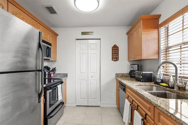 a kitchen with a refrigerator and a sink