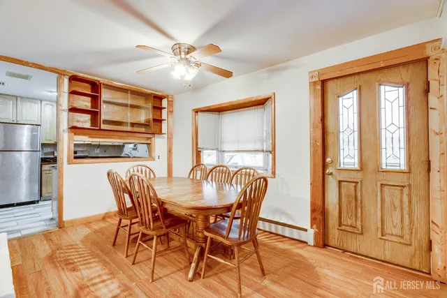 a dining room with furniture a chandelier and wooden floor