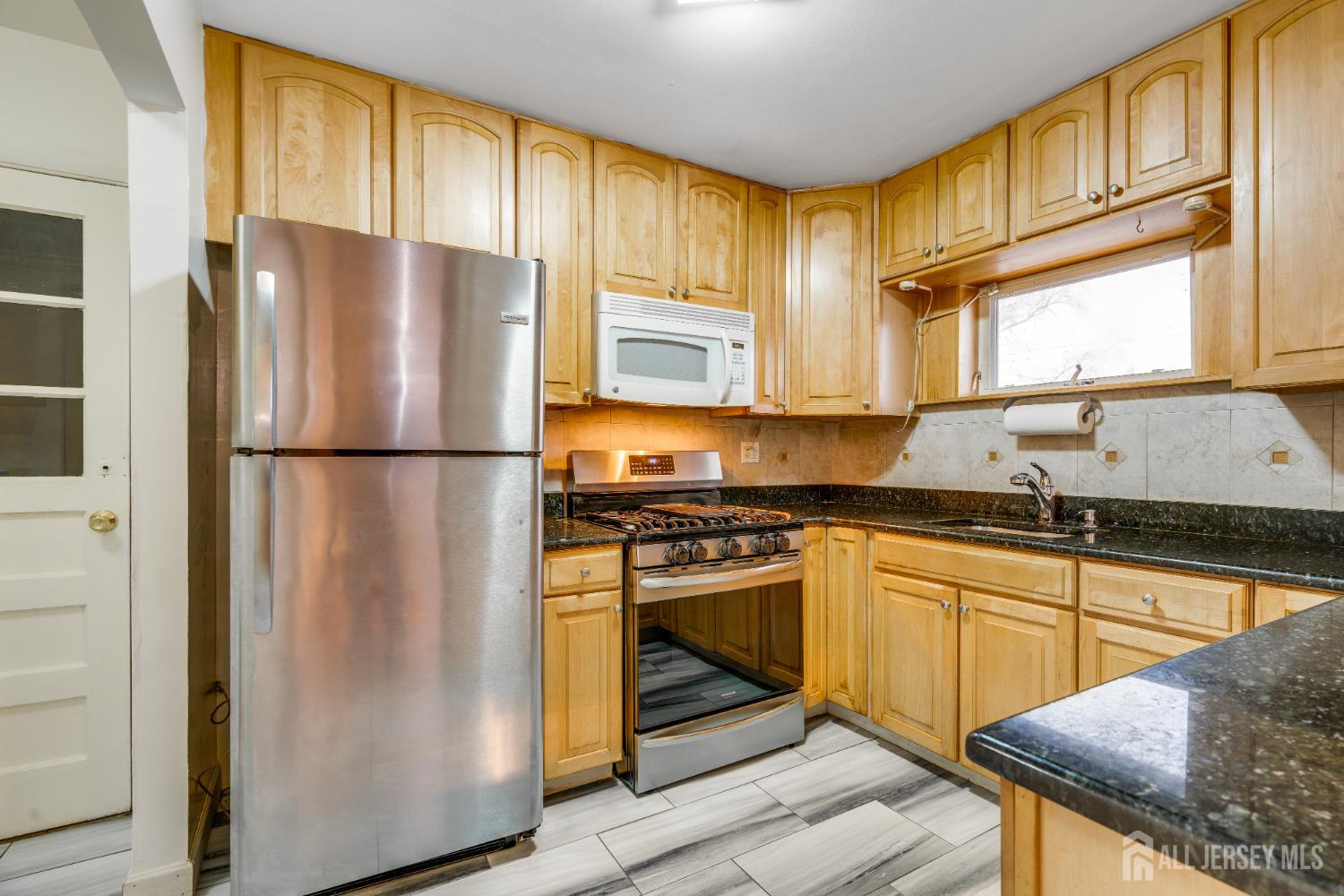 6 Woodrow Road Kendall Park, NJ 08824 - Photo 4 of 18 a kitchen with stainless steel appliances granite countertop a refrigerator sink and cabinets