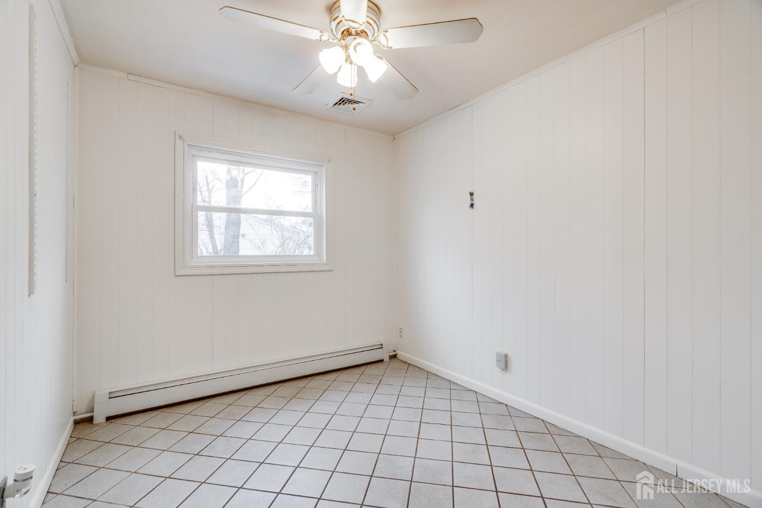 6 Woodrow Road Kendall Park, NJ 08824 - Photo 9 of 18 a view of an empty room with a window