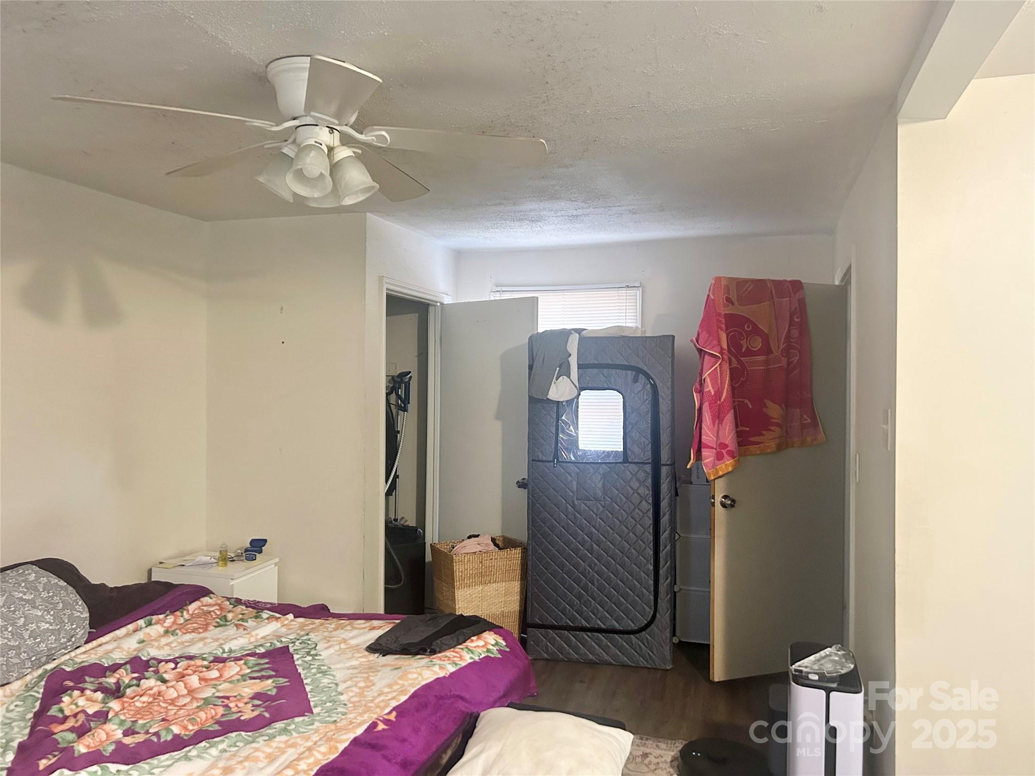 306 Valley Street Stanley, NC 28164 - Photo 5 of 19 a bedroom with a bed and a chandelier