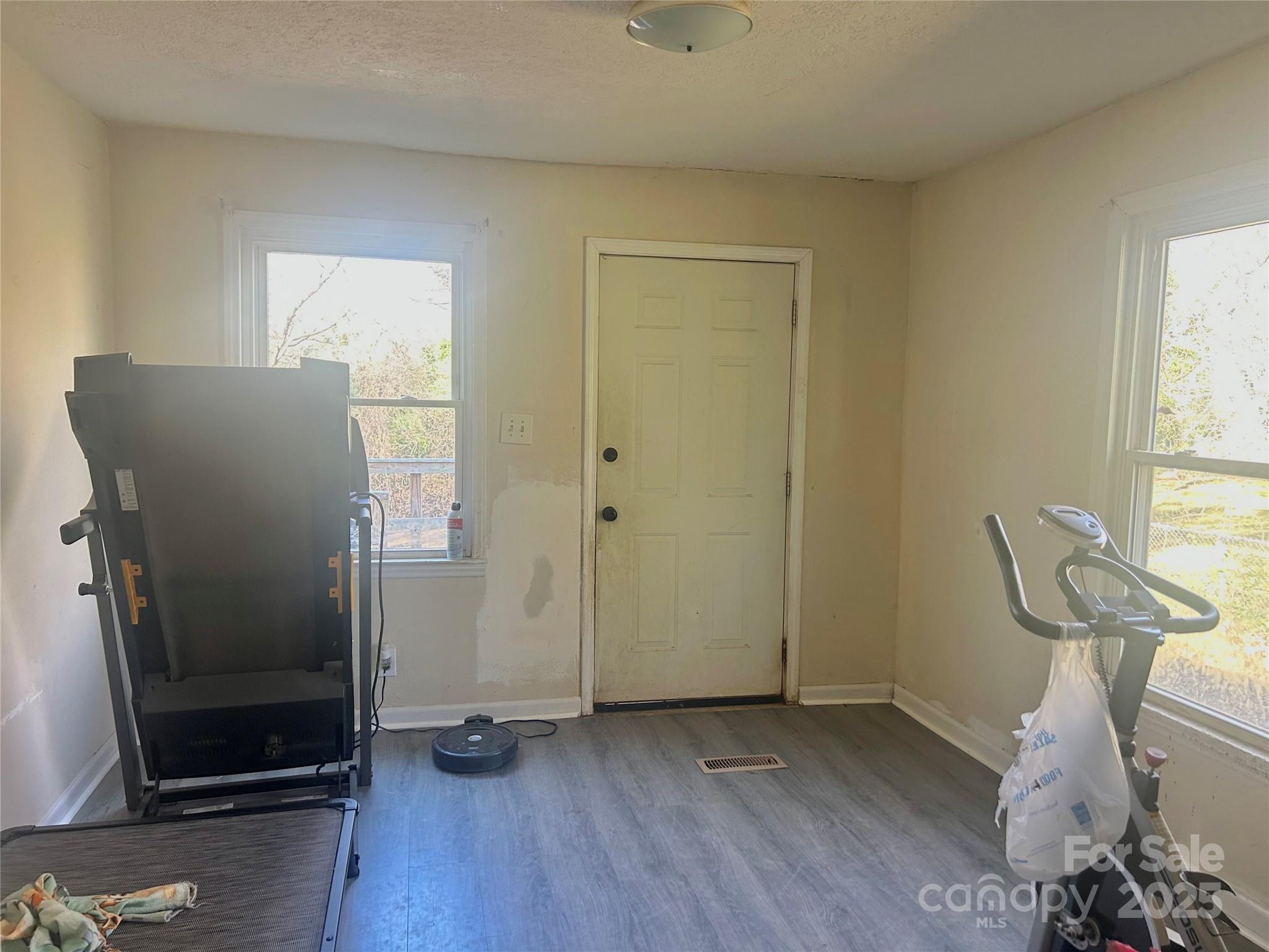 306 Valley Street Stanley, NC 28164 - Photo 8 of 19 a view of a livingroom with wooden floor and chair