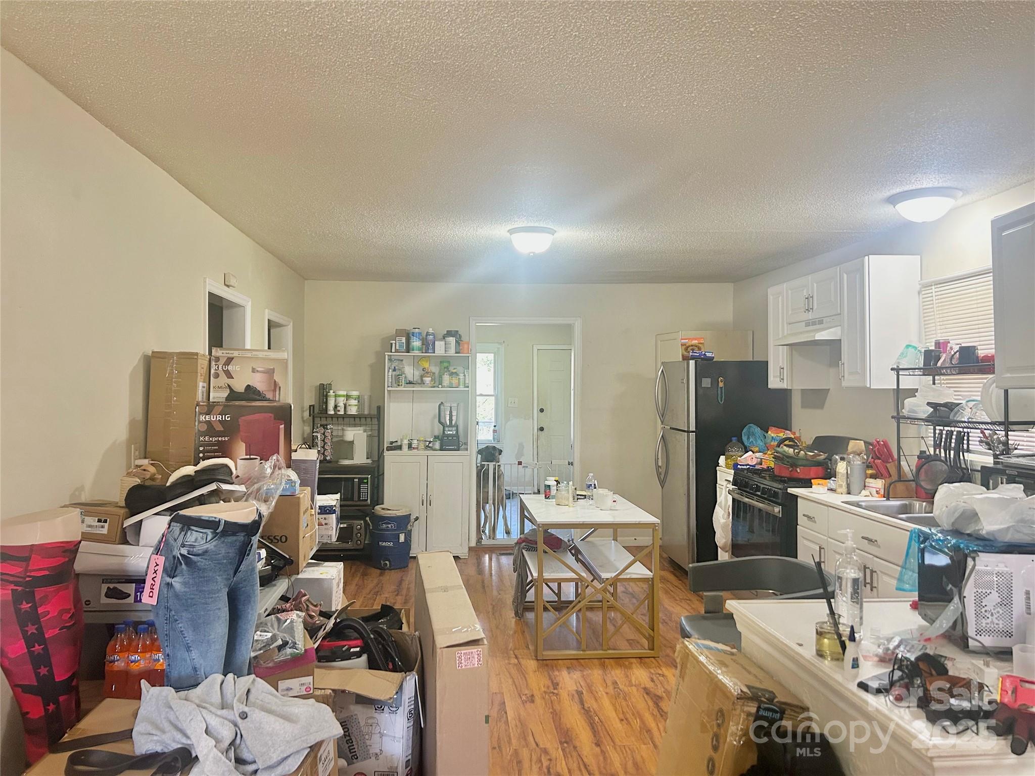 306 Valley Street Stanley, NC 28164 - Photo 9 of 19 a view of a workspace with furniture and a living room