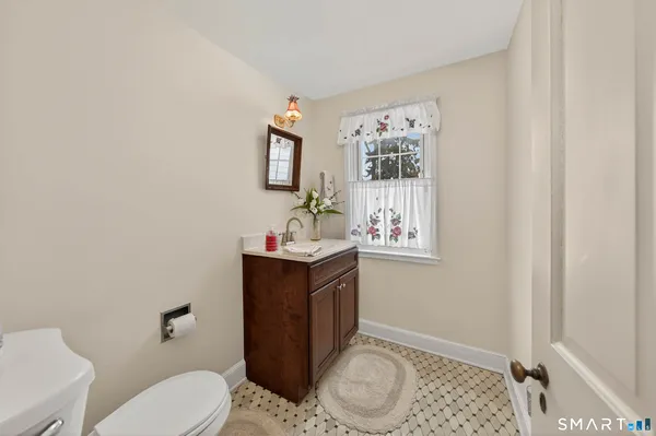 a kitchen with stainless steel appliances granite countertop a stove a sink dishwasher a dining table and chairs with wooden floor