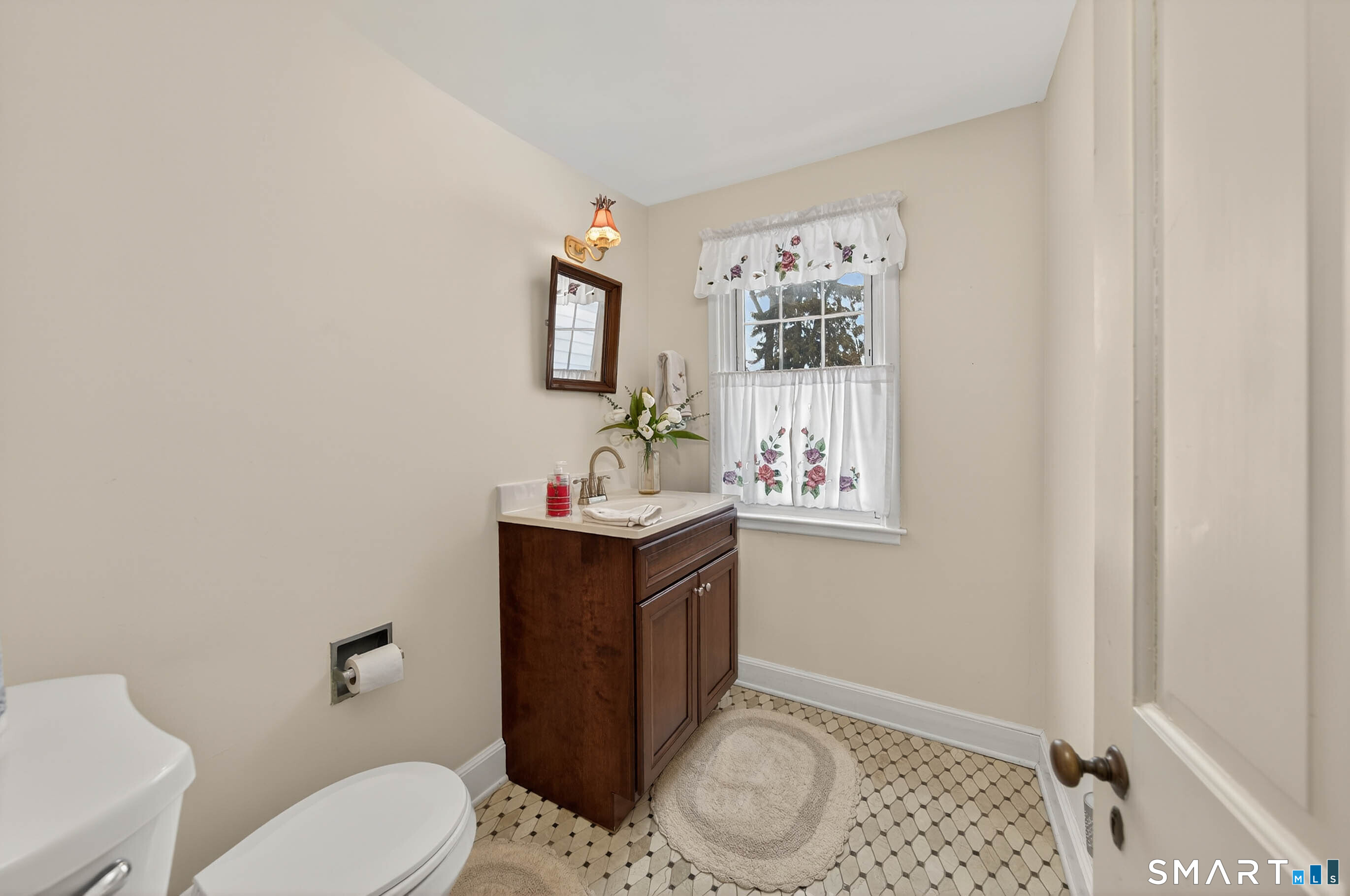 85 Cherry Hill Road Branford, CT 06405 - Photo 23 of 40 a bathroom with a toilet sink and mirror