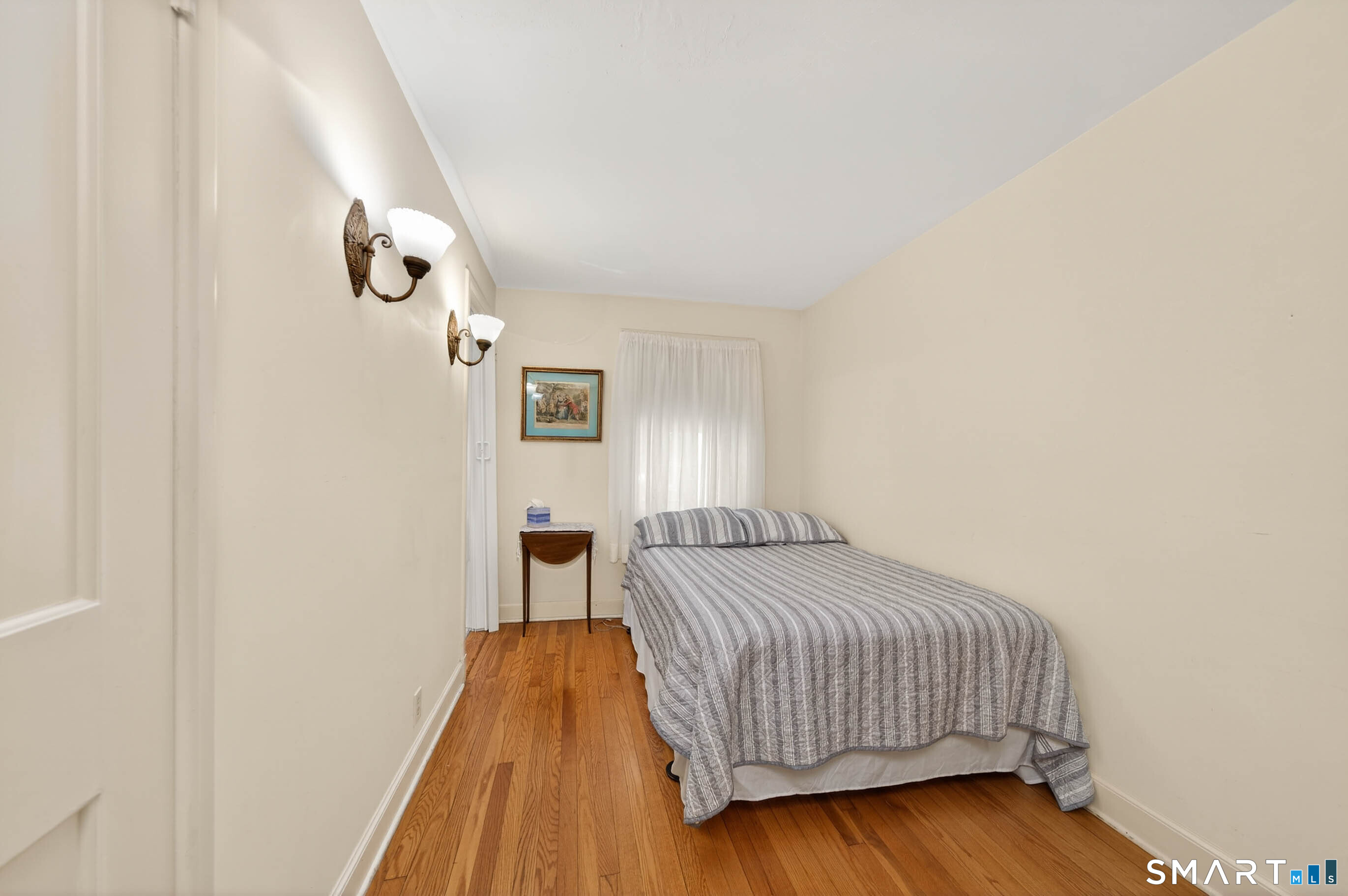 85 Cherry Hill Road Branford, CT 06405 - Photo 26 of 40 a bedroom with a bed and wooden floor