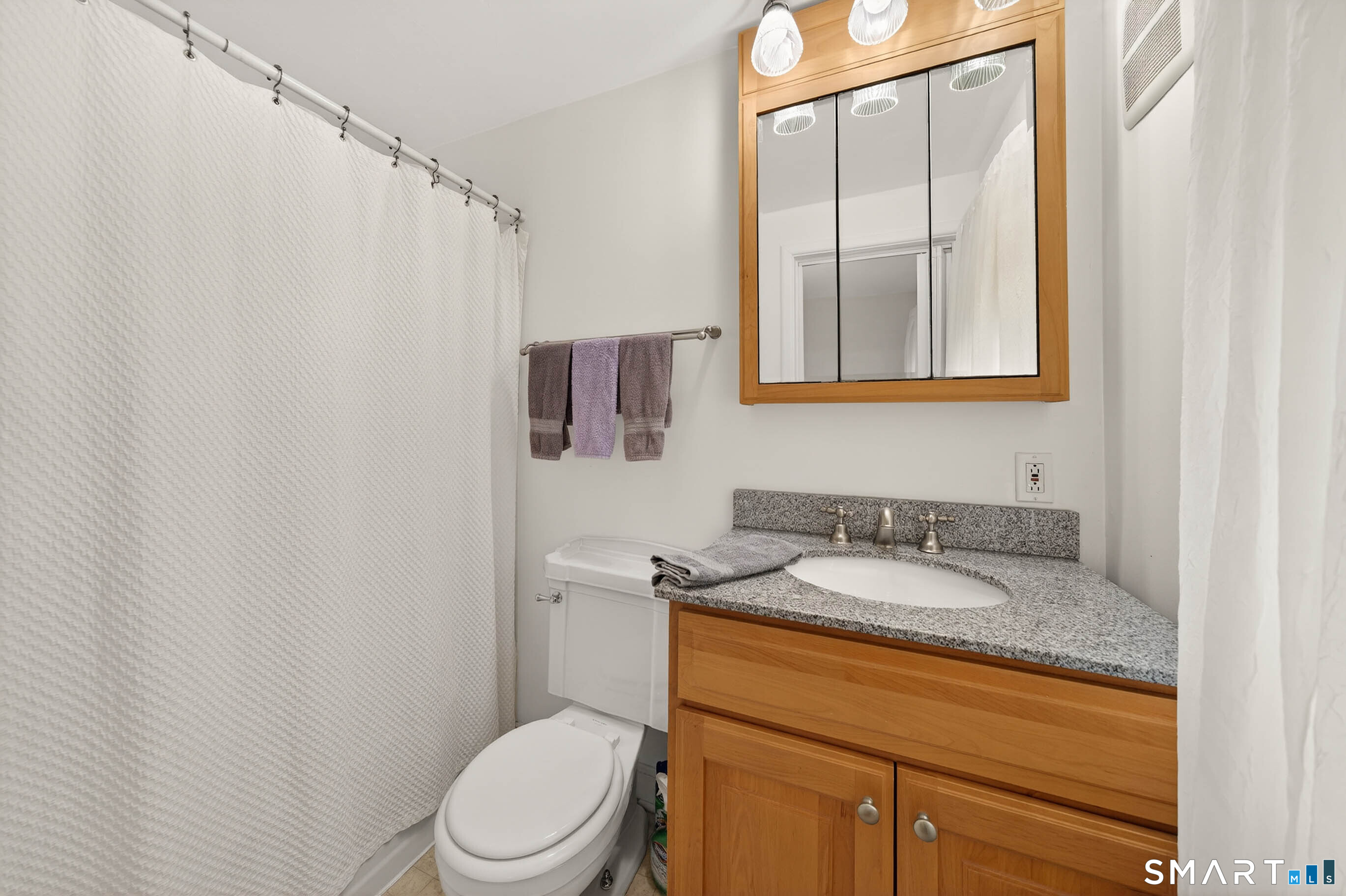 85 Cherry Hill Road Branford, CT 06405 - Photo 27 of 40 a bathroom with a granite countertop sink toilet and mirror