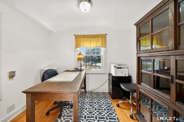 a bedroom with a large bed and a fireplace