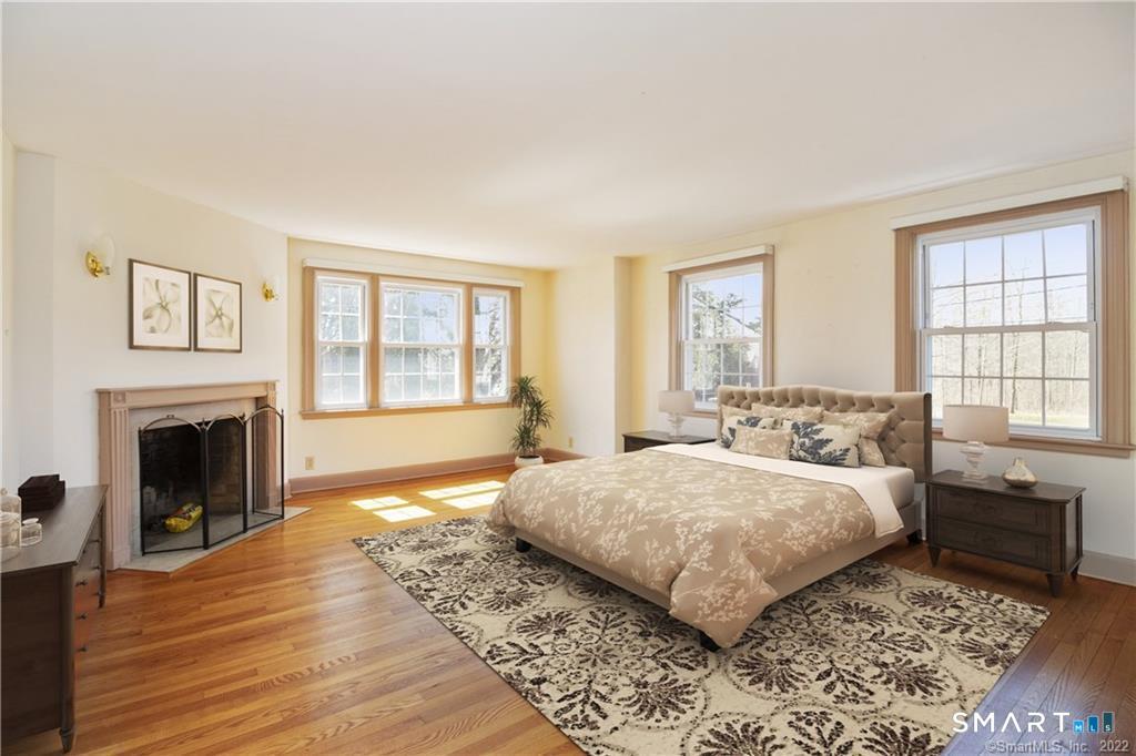 85 Cherry Hill Road Branford, CT 06405 - Photo 30 of 40 a bedroom with a large bed and a fireplace