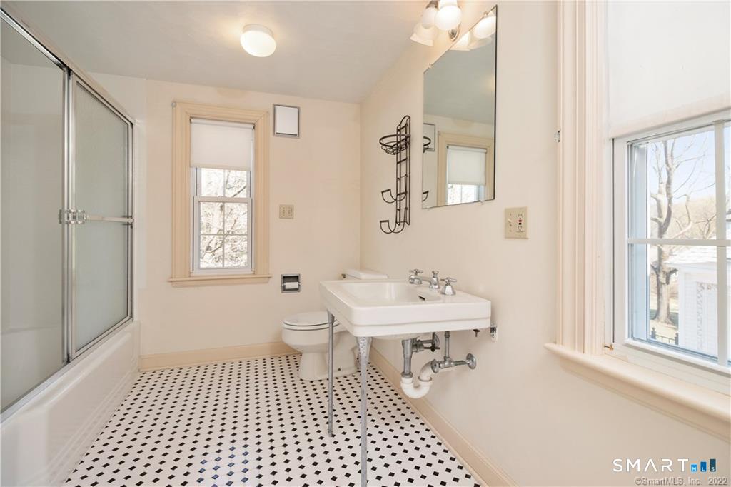 85 Cherry Hill Road Branford, CT 06405 - Photo 31 of 40 a bathroom with a sink a toilet a mirror and next to a window