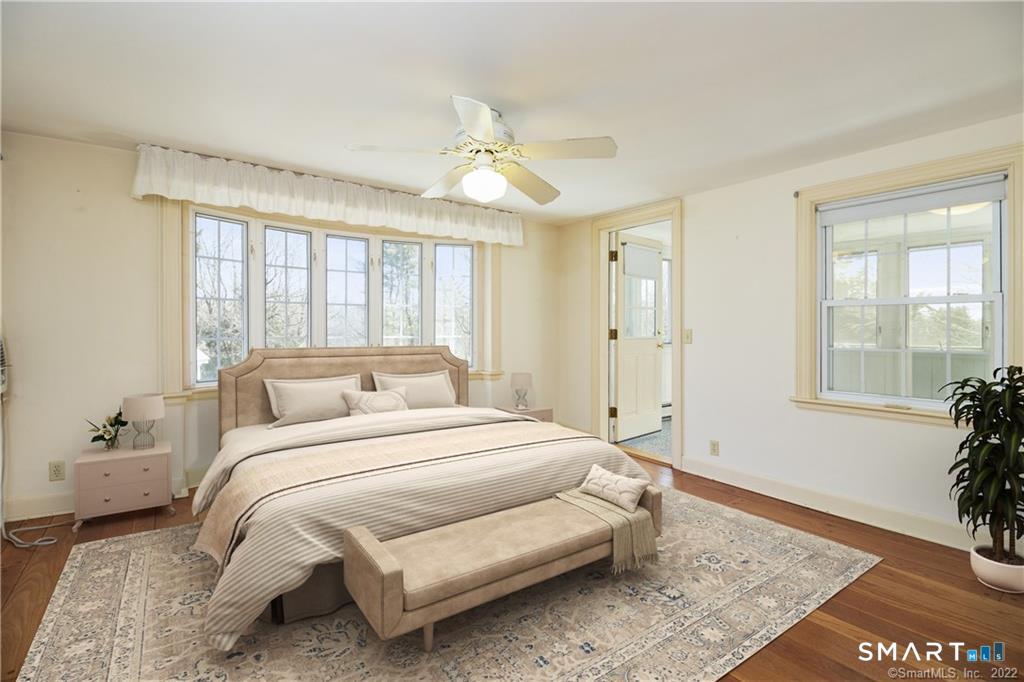 85 Cherry Hill Road Branford, CT 06405 - Photo 34 of 40 a bedroom with a large bed and a chandelier