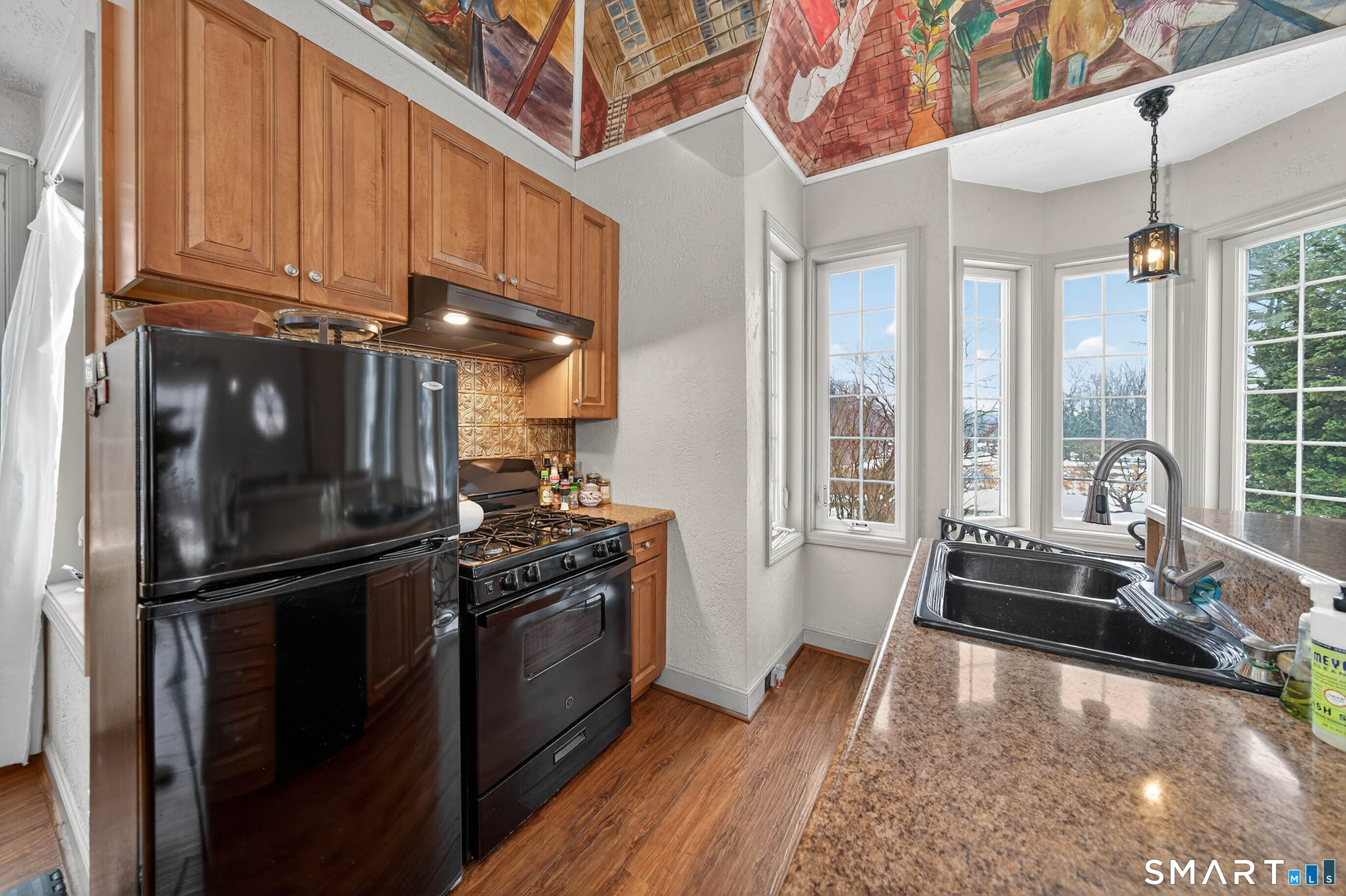 85 Cherry Hill Road Branford, CT 06405 - Photo 10 of 40 a kitchen with stainless steel appliances granite countertop a refrigerator a stove and a sink with wooden floor