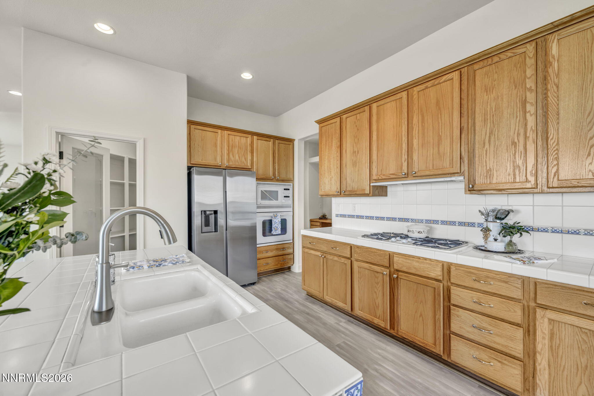 574 Echo Ridge Court Reno, NV 89511 - Photo 27 of 58 a kitchen with stainless steel appliances granite countertop a sink a stove and cabinets