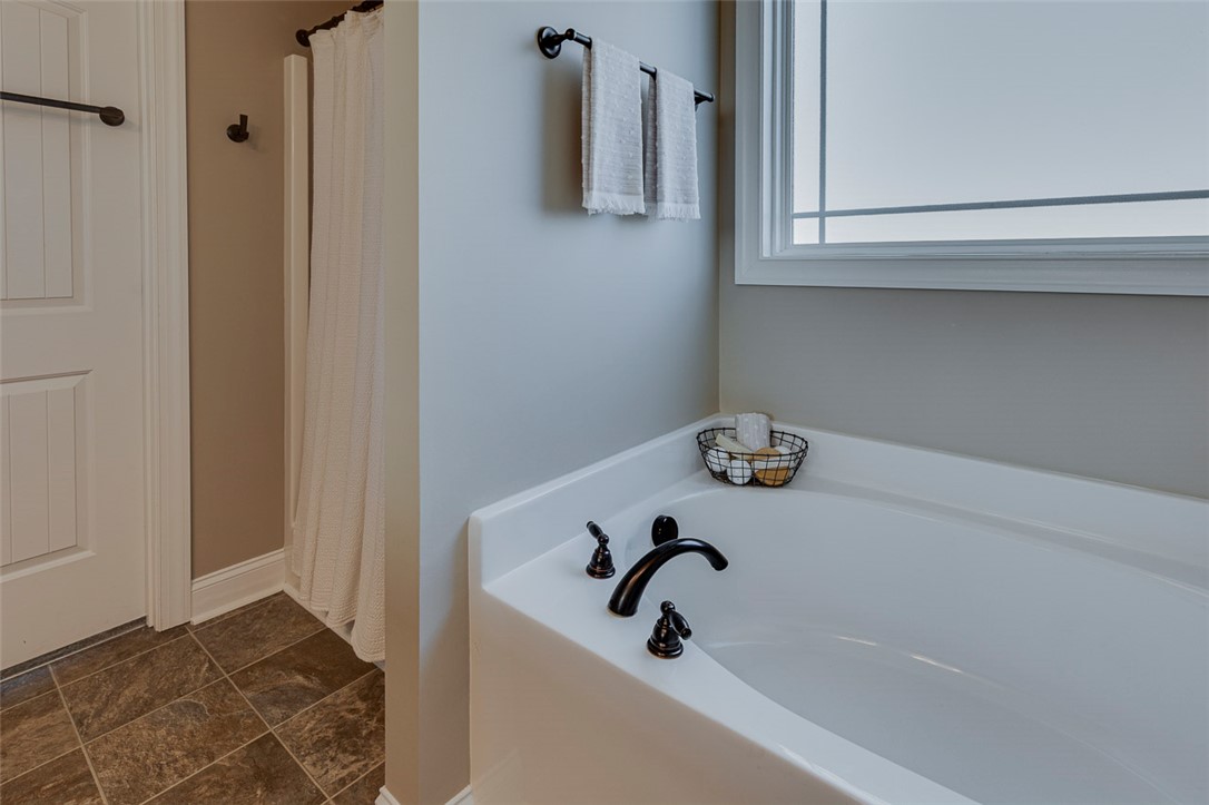 203 Streams Way Anderson, SC 29625 - Photo 11 of 47 Relax and unwind in this inviting bathroom featuring a deep soaking tub and elegant fixtures.
